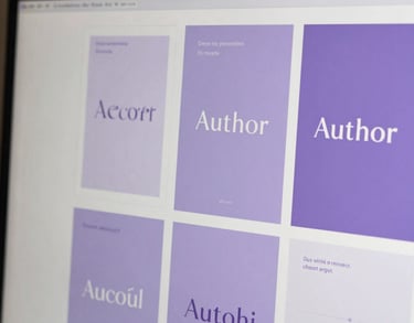 Close-up of a digital design mood board on a screen, featuring sophisticated typography and lavender color palettes for an author's personal brand.