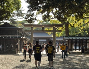 Tourists walking toward the wooden Torii gate entrance of Meiji Jingu Shrine in Tokyo, Japan.