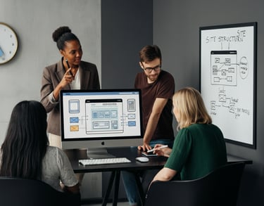 Verve Phoenix designers optimizing website UX/UI with user flow diagrams and wireframes in a gold and black workspace.