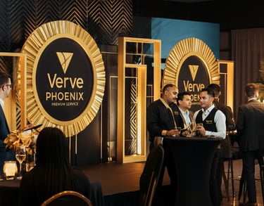 Verve Phoenix event with elegant gold-accented decor, a professional stage setup, and an engaged audience