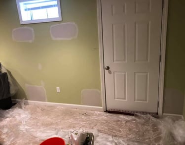 drywall repairs on a green wall smooth patching