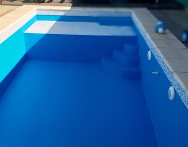 a pool with a blue pool and a pink ball