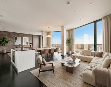 Luxury open-concept penthouse featuring a modern living room, dining area, and kitchen with panoramic city views.