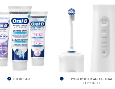 a group of Oral B toothbrushes and toothpaste