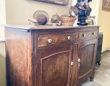 Image of a sideboard that is brown wood and could be painted