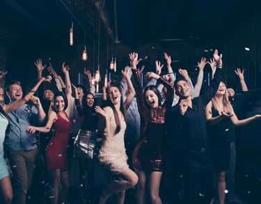 Group celebrating at a VIP private club crawl in Las Vegas with dancing and confetti.