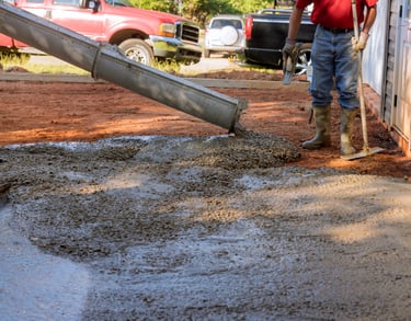 a man is pouring cement into a concrete wall