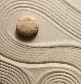 a stone in a sand dune with a stone in the sand