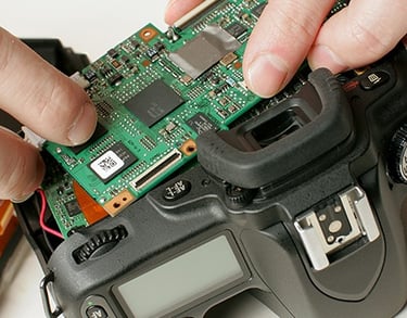 Camera technician removes faulty PCB
