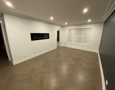 Custom herringbone hardwood flooring installation with modern fireplace in a Chicago North Shore home