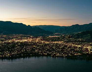 Kelowna city lights at night representing our mission of local community restoration and faith.