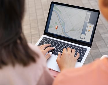 Customer doing a local business search for businesses in their area on a laptop outside.