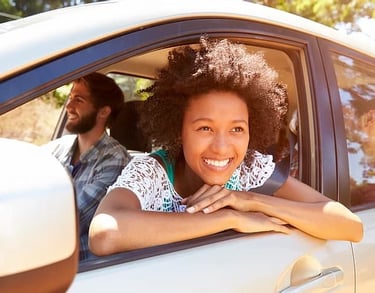 Happy Learner leaning out of car window