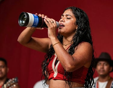 A South American / Brazilian Amazonian candid shot of a lead singer pouring her heart out during a live regional festival in Santa Bárbara do Pará. Warm spotlight illumination, vivid background colors of deep carmine red.