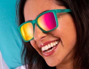 Woman smiling wearing bright polarized sunglasses