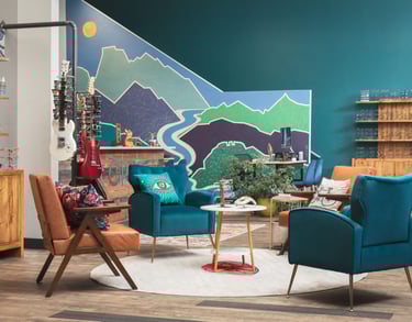 Interior of Edge Optics Fort Collins location, with the mountain mural, stylish seating, and guitars