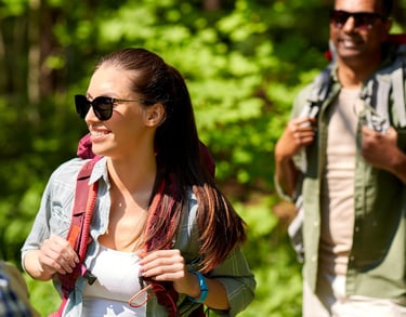 Two people hiking wearing protective sunglasses