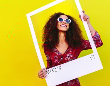 Woman wearing designer frames and holding up a social media post
