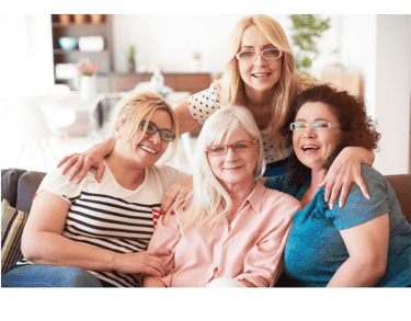A group of women smiling and wearing a practical eyewear