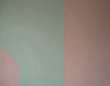 A detail of a wall with minimalist artwork in sage green and dusty rose tones, elegant Southern European / Italian interior design.