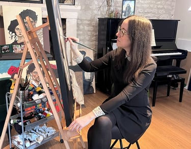 manef working on a portrait painting in her studio