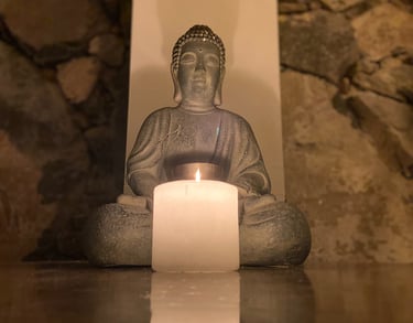 buddah statue with candle in front