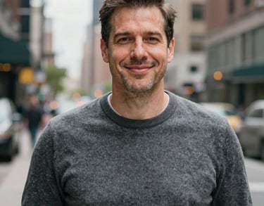 A professional portrait of a man in a professional grey sweater, appearing trustworthy and welcoming, North American urban backdrop.