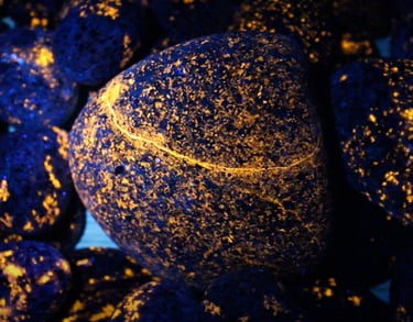Orange glowing yooperlite rocks under 365nm uv light.