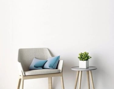 a chair and a table with a plant in a room
