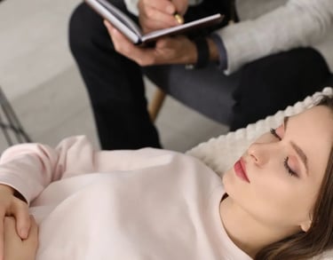 a woman is laying on a couch with a man in a suit and tie