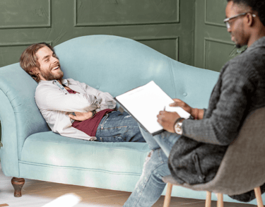 a man sitting on a couch in a room