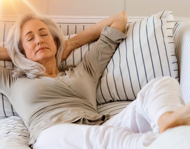 a woman is laying on a couch with her eyes closed