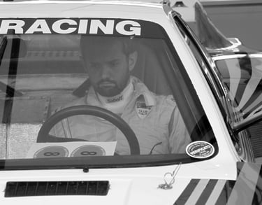 A racing driver sitting in his car at the Goodwood Festival of Speed