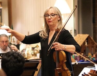 An image of the orchestra's director, Luanne.