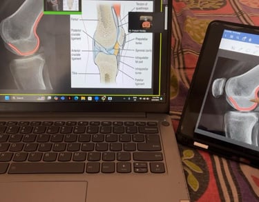 Physiotherapy educator marking X-rays on a ipad during an online teaching session.