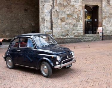 a small car parked in front of a building