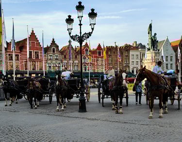 a group of people riding horses in a city