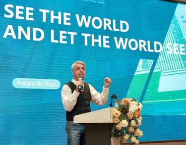 Professional speaker Paul giving a keynote presentation at a global conference event.