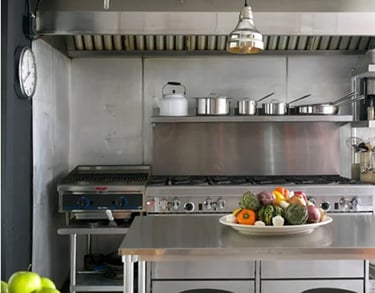 Commercial kitchen stove and prep area featured on our Frequently Asked Questions page.