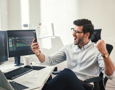 a man sitting at a desk with a laptop and a laptop