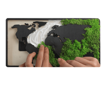a person holding a piece of paper with a map of the world