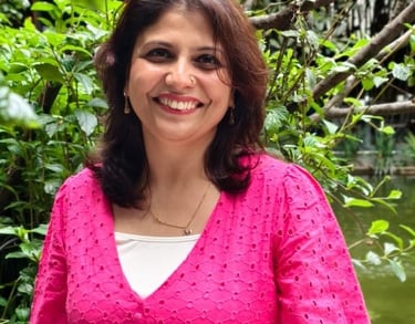 image of Shruti Pushkarna smiling at the camera wearing pink