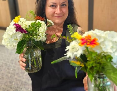 portrait of owner holding flowers