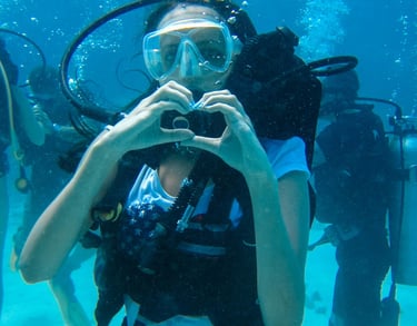 a woman in a diving suit is taking a selfie