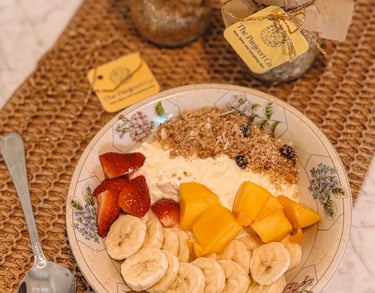 A plate of fresh fruit served with creamy yogurt, a healthy pairing for Panjeeri.