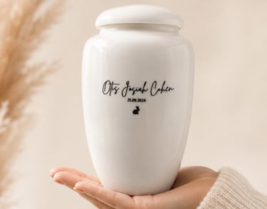 Personalised white ceramic urn for baby ashes with engraved name, birth date and custom illustration
