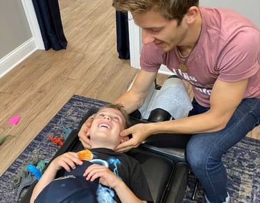 Happy child getting adjusted to help calm their nervous system to sleep better in Franklin, TN