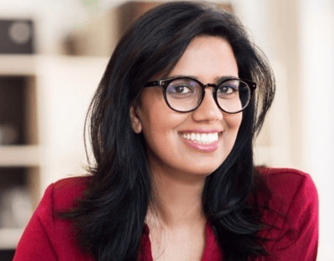 a woman in a red shirt and glasses
