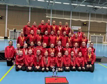 a group of people standing around a trophy, after baton/twirling competition