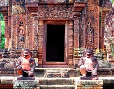 a group of monkeys sitting on steps leading to a doorway